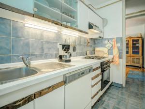 a kitchen with white cabinets and a sink at Apartment Iris Croatica by Interhome in Veruda
