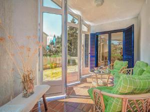 a living room with green chairs and a table at Apartment Iris Croatica by Interhome in Veruda +18 photos