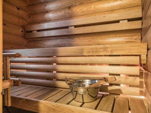 a sauna with a bucket on a wooden platform at Holiday Home Riekonmarja by Interhome in Äkäslompolo +15 photos