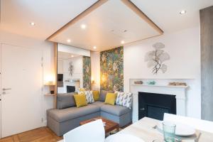 a living room with a couch and a fireplace at Le Petit Botte in Rennes