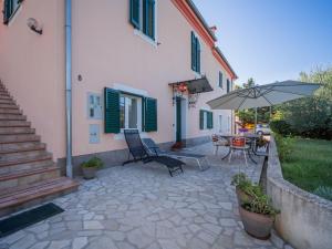 a patio with a table and an umbrella at Apartment Adriana by Interhome in Pješčana Uvala 