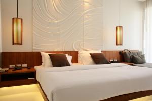 Postel nebo postele na pokoji v ubytování G Hua Hin Resort & Mall