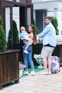 a woman holding a baby and a man holding a baby at Bon Son Hotel and Hostel Центр in Voronezh