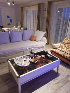 a living room with a couch and a coffee table at Nautilus in Iraklitsa