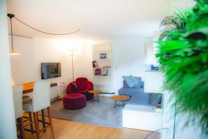 a living room with a couch and chairs and a tv at Kassel in Kassel