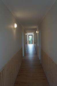 a hallway of an empty room with a long corridor at Przy morzu in Dziwnówek