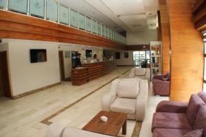 a lobby with chairs and a table and a bar at Anemon Trabzon Hotel in Trabzon