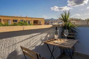 two glasses of wine sitting on a table on a balcony at L’Ancora Suite in Jávea
