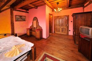 a bedroom with a bed and a tv in a room at Apartmány Village in Veľký Slavkov
