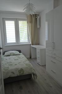 Posteľ alebo postele v izbe v ubytovaní Apartamenty Marii Konopnickiej