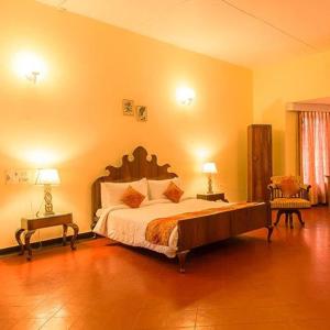 a bedroom with a large bed and two night tables at Ama Plantation Trails, Chikmagalur in Chikmagalūr
