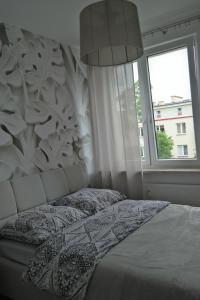 Posteľ alebo postele v izbe v ubytovaní Apartament Grochowa