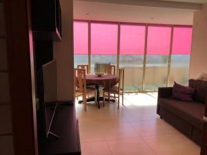 a living room with a table and a couch at Bed and Breakfast en Salou in Salou