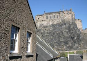 a castle sitting on top of a mountain at The Webstersland Residence in Edinburgh