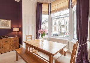 a dining room with a table and a window at The Coates Gardens Residence in Edinburgh