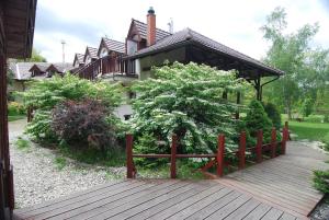 a wooden walkway in front of a house at Ivanek guest house in Zvíkovské Podhradí