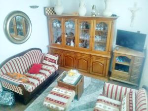 a living room with two couches and a tv at Apartment Rita in Ston