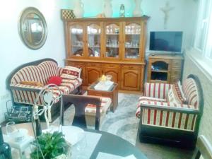 a living room with two chairs and a table at Apartment Rita in Ston +15 photos