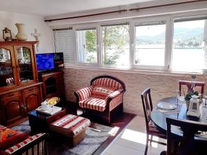 a living room with a couch and a chair and a table at Apartment Rita in Ston
