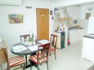 a kitchen with a table and chairs in a room at Apartment Rita in Ston