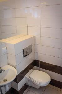 a white toilet sitting next to a white sink at BeskidPark in Bielsko-Biała