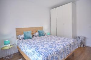 ラス・ガジェタスにあるApartamento Sol y Marのベッドルーム(青い枕の大型ベッド1台付)