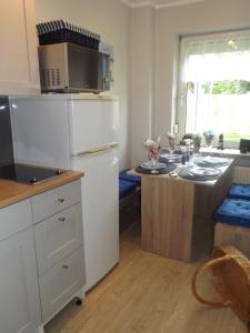 a kitchen with a white refrigerator and a counter at Ferienwohnung Ostseenähe in Schönberg