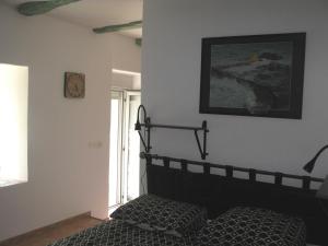 a bedroom with a bed and a picture on the wall at Domaine du Bel Air in Casson