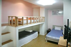 a room with two bunk beds and a bed at Mama Guesthouse Myeongdong in Seoul