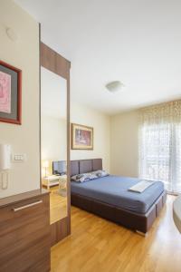a bedroom with a bed and a large window at Zebra in Podgorica