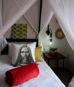 a bed with a portrait of a woman on it at Etotongwe Lodge in Outjo
