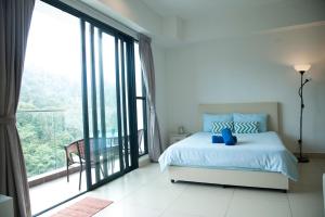 Postel nebo postele na pokoji v ubytování Resort Suite @Midhill Genting