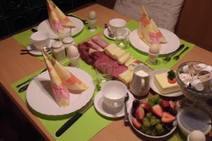 a table with plates of food and fruit on it at Gasthaus Beyersdorfer in Rieth