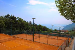 a tennis court with two tennis nets on it at Appartamenti Morele in Tignale +55 photos