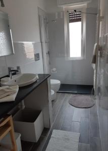 a bathroom with a sink and a shower and a toilet at APPARTAMENTO nonni FRANCHI in Loano