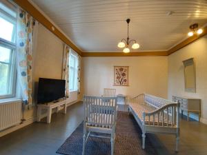 a living room with two chairs and a flat screen tv at B&B Taipaleenniemi in Savonlinna