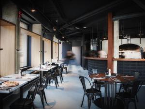 a row of tables and chairs in a restaurant at The Loft Hotel Adults Only in Kraków