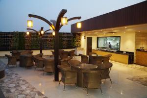 a restaurant with a bunch of tables and chairs at HOTEL SHIVOY GRAND in Varanasi