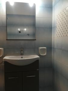 a white bathroom with a sink and a mirror at Sogno nel blu in San Vito lo Capo