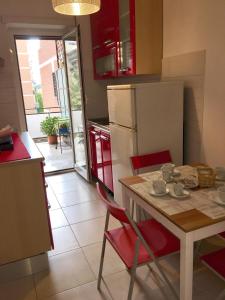 Il comprend une cuisine équipée d'une table, de chaises et d'un réfrigérateur. dans l'établissement Casa Milù, à Rome