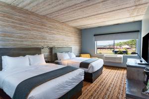 A bed or beds in a room at Pier B Resort