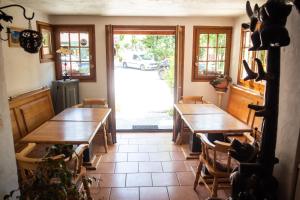 a dining room with two tables and a view of a car at Hotel Relais Saint Louis in Saint-Martin-Vésubie +12 photos