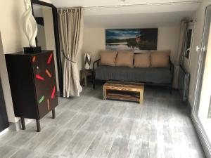 a living room with a couch and a coffee table at La Ravine au bord du loing in Montigny-sur-Loing