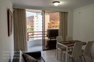 a dining room with a table and a balcony at Condominio Nuevo Rodadero 1204 in Santa Marta