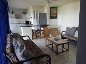 a living room with a couch and a table at The Seaside in Scottburgh