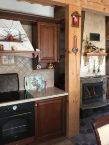 a kitchen with a stove and a fireplace at Domek nad stawem in Sławutowo