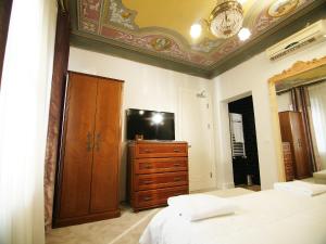 a bedroom with a bed and a tv at Faik Pasha Hotels Special Category Beyoglu Istanbul in Istanbul