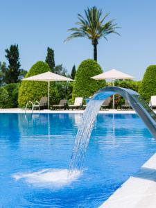 a water fountain in a swimming pool at Son Julia Country House & Spa in Llucmajor