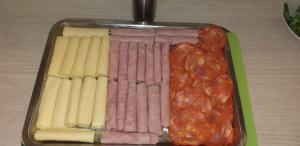 a tray of hot dogs and a row of sausage at Sensations Guesthouse in Lagos