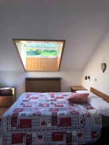 a bedroom with a bed with a quilt on it at Residence Ables in Valfurva